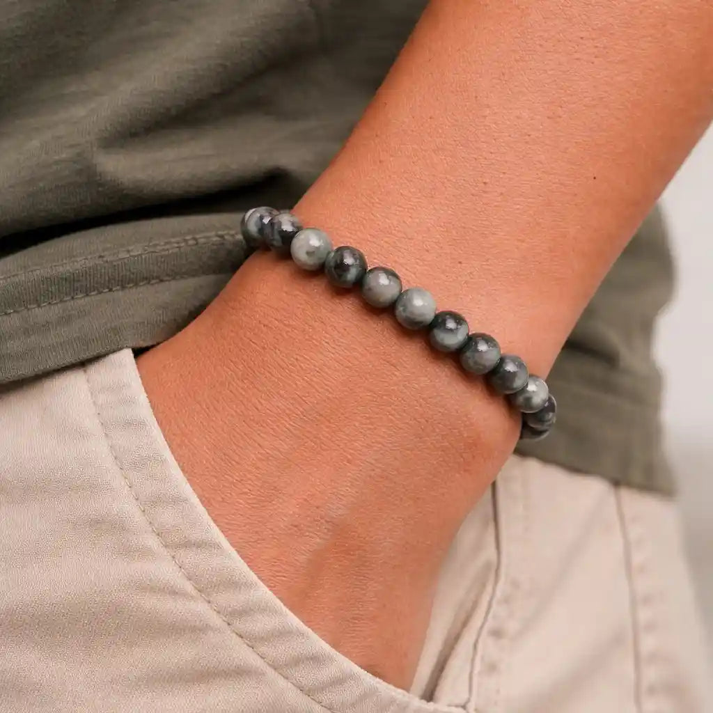 Person Wearing Gray Cat's Eye Bracelet