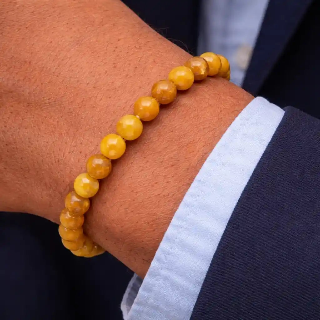 Person Wearing Yellow Cat's Eye Bracelet